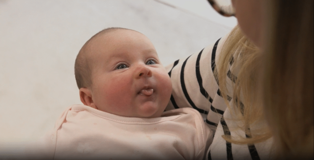 Baby held in her mother's arms