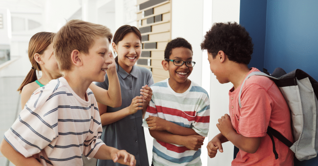 Group of smiling school-age children talking and laughing together.